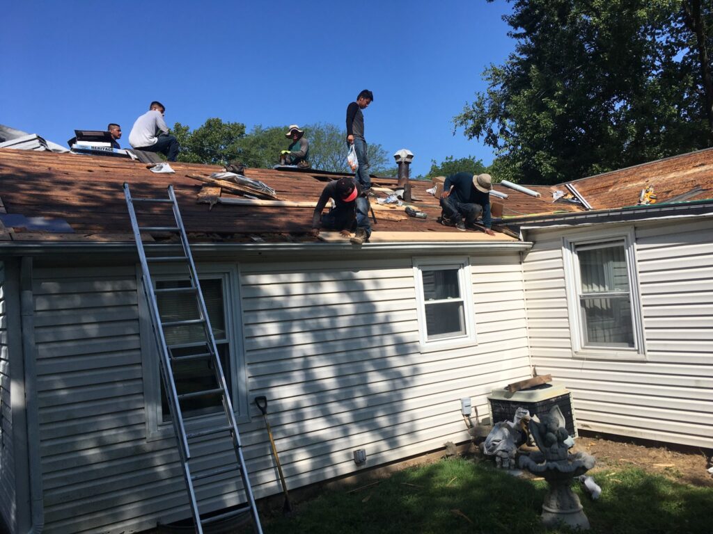 Roofers working on new roof on residential home in Kansas city