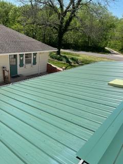 Roofers working on new roof on residential home in Kansas city