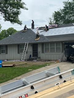 Roofers working on new roof on residential home in Kansas city