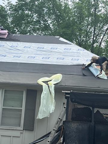 Roofers working on new roof on residential home in Kansas city