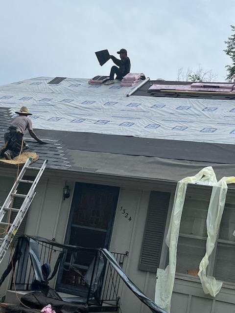 Roofers working on new roof on residential home in Kansas city