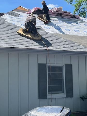 Roofers working on new roof on residential home in Kansas city