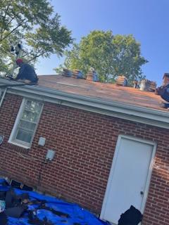 Roofers working on new roof on residential home in Kansas city