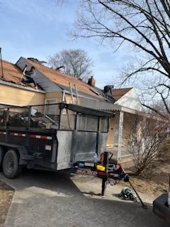 Roofers working on new roof on residential home in Kansas city