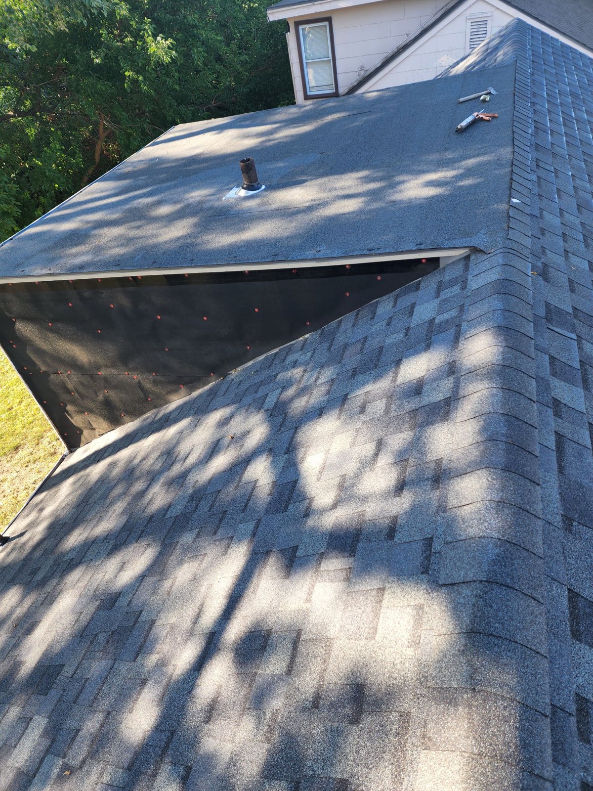 Roofers working on new roof on residential home in Kansas city